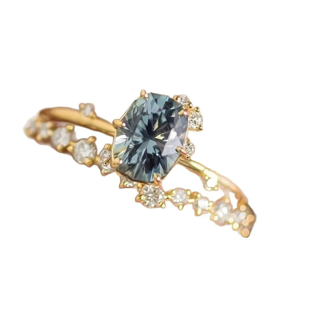 Gold plated women's ring with green zircon stone in floral design on model finger