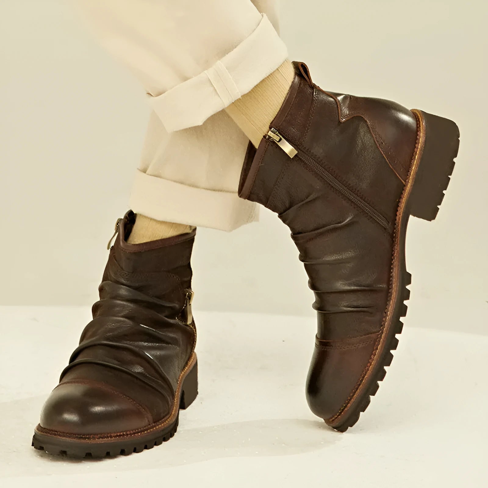 Black mid-calf cowboy boots with a side zipper, round toe, and a horseshoe heel on a plain background.