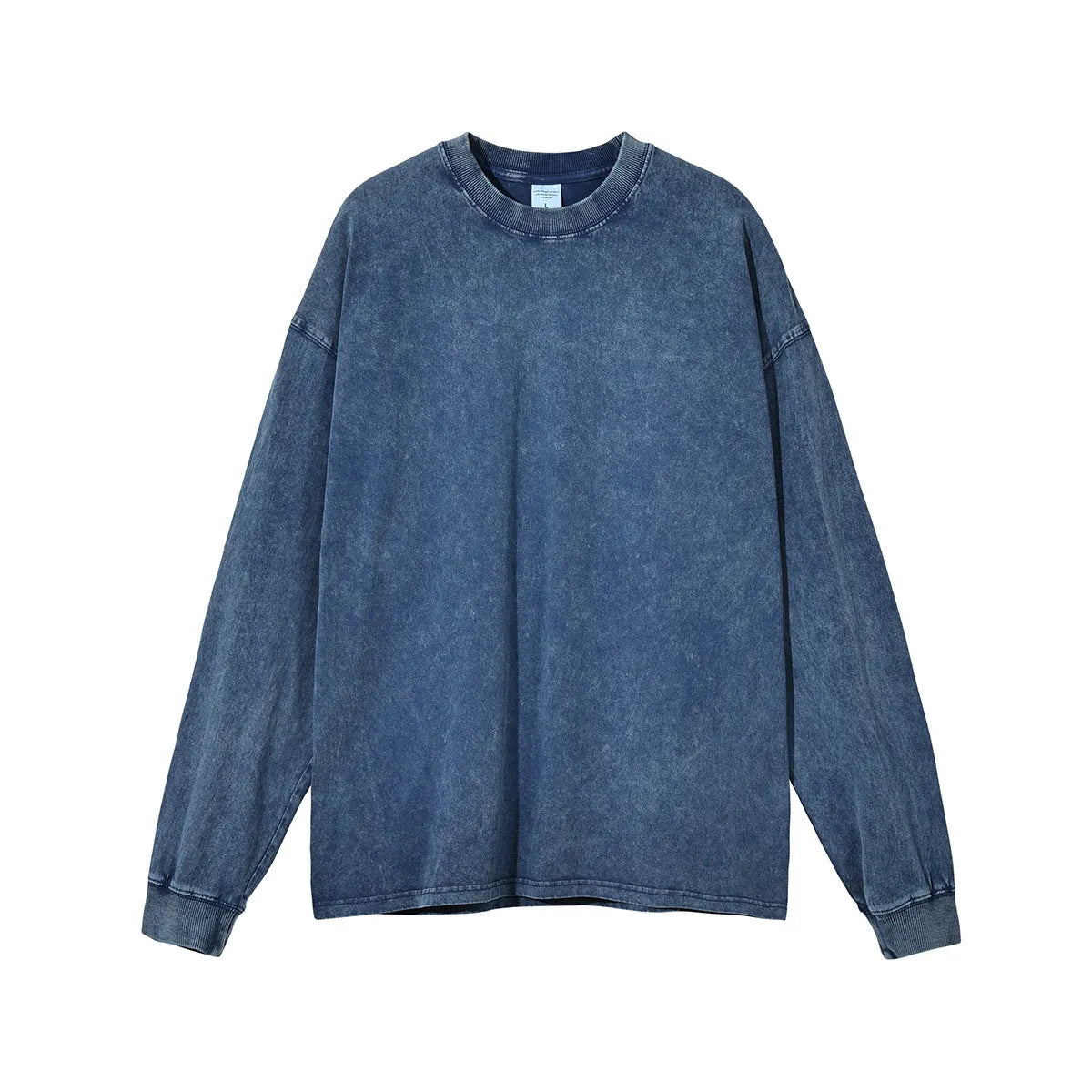 Man wearing a loose-fit batik print long sleeve cotton pullover top in a vintage washed colour.