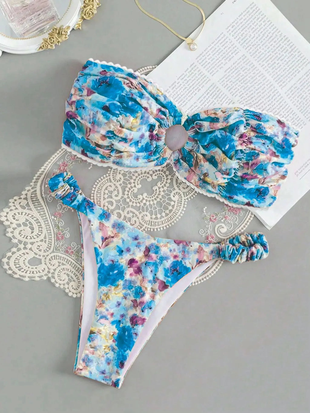 Blue floral print bikini set with lace trim on a sleeveless tube top and matching briefs.