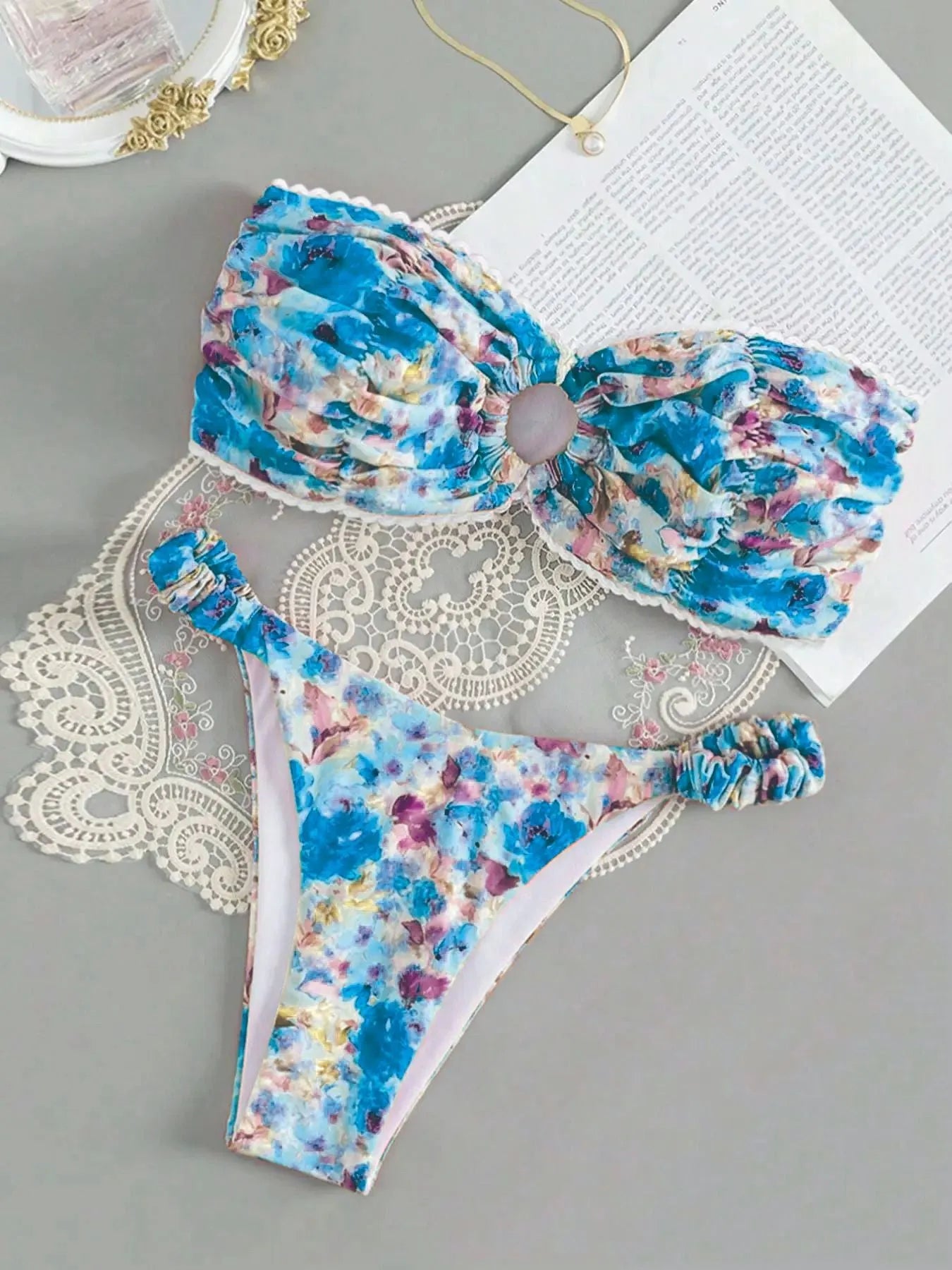 Blue floral print bikini set with lace trim on a sleeveless tube top and matching briefs.