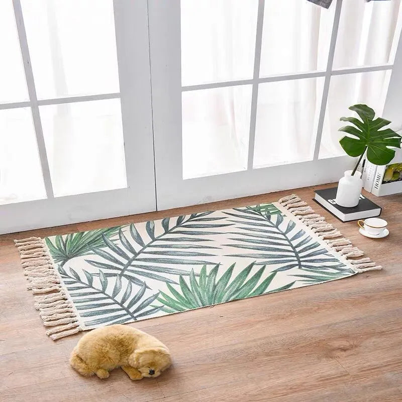 Handwoven cotton linen floor mat 60x90cm in ethnic style with natural plant dye, placed on a wooden floor