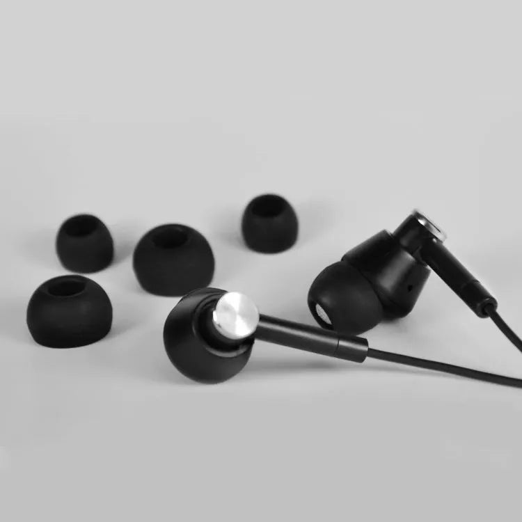 Black and white in-ear earphones with subwoofer for computer and mobile phone.