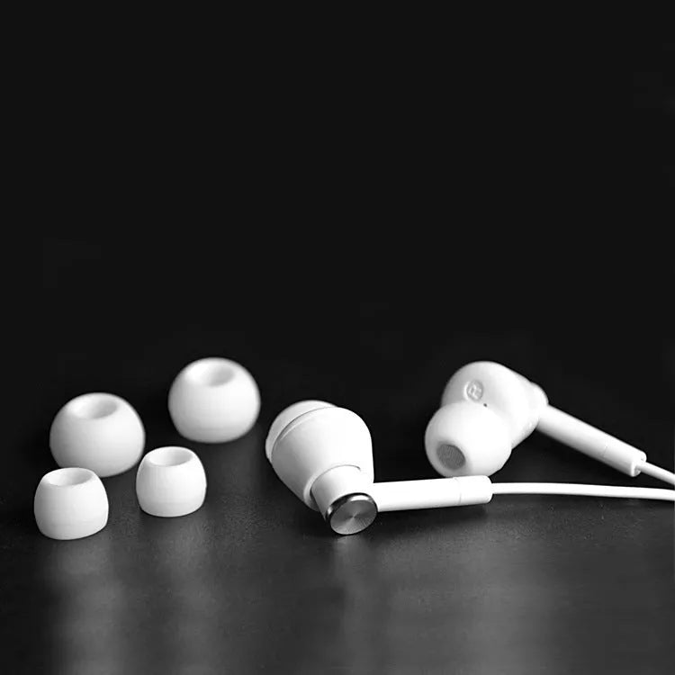 Black and white in-ear earphones with subwoofer for computer and mobile phone.