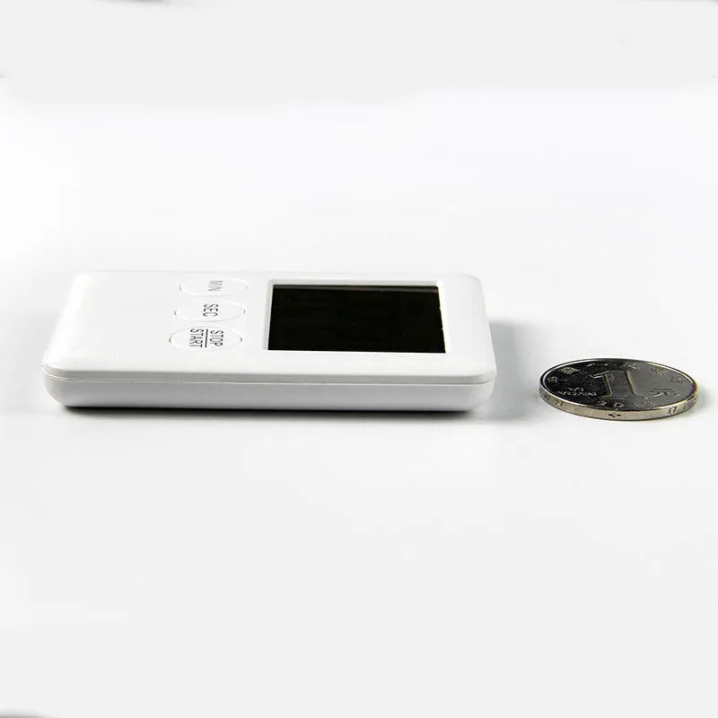 Black or white plastic digital kitchen timer with LCD display and magnetic back.