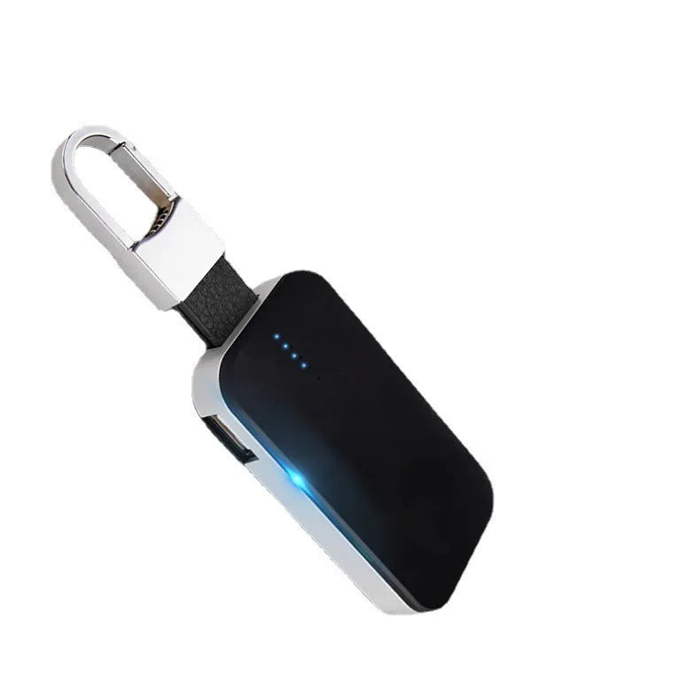 Black Apple Watch portable wireless power bank on a keyring showing compact size.