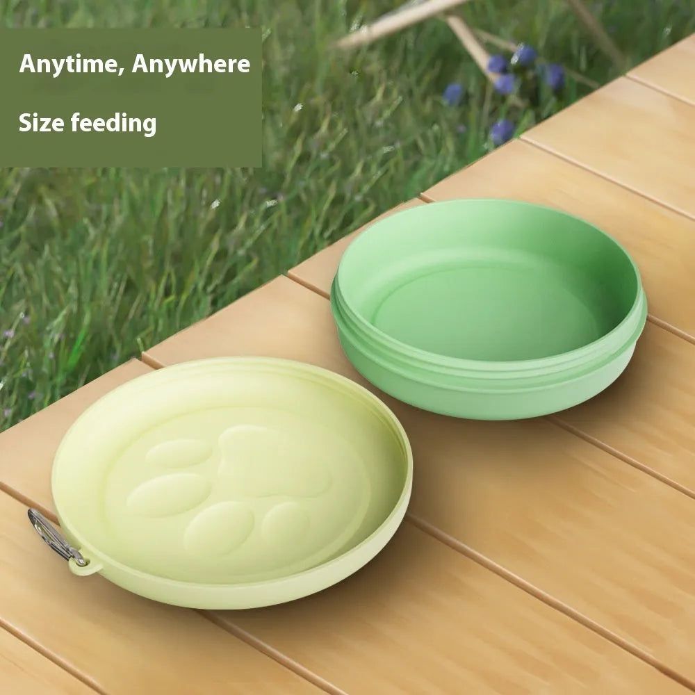 Portable dual-colour dog bowl set with attached snack box in light green and pink.