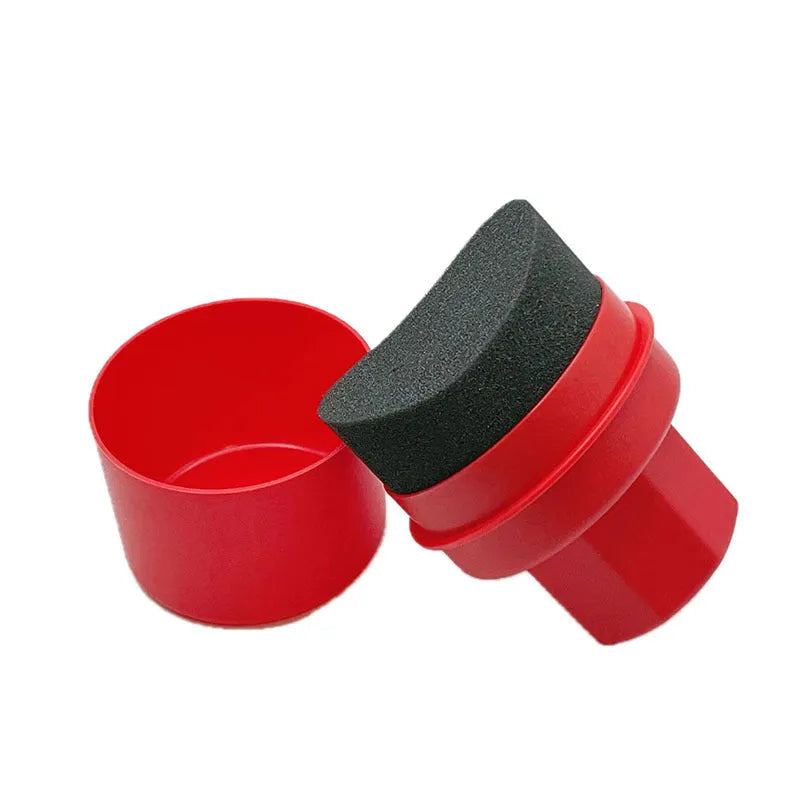 Black car tyre polishing sponge brush with a red lid, showing its size next to a car tyre.