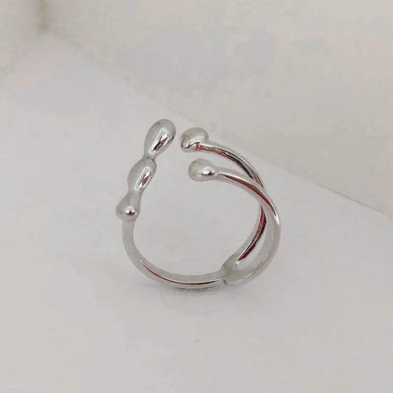 Brass spherical ring for women in gold or silver colour on a circular band.