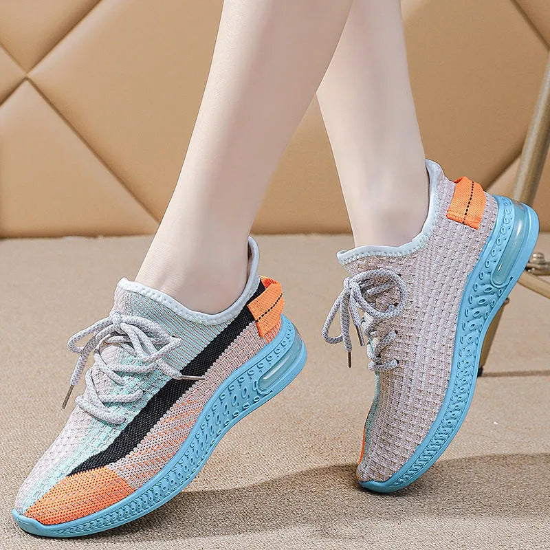 Women's lightweight casual running shoe in purple with front lace-up, round toe, and flat heel.