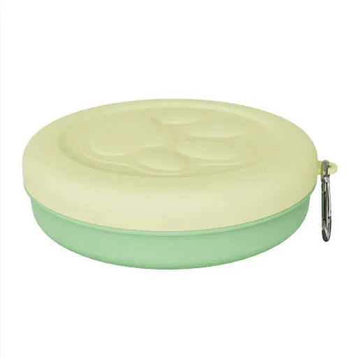 Portable dual-colour dog bowl set with attached snack box in light green and pink.