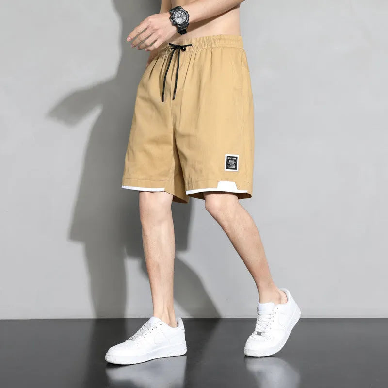 Boys' cotton shorts in black, khaki, or white, showing mid-waist and shorts length design.