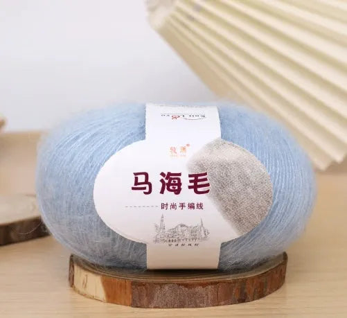 Ball of mohair yarn for DIY scarf knitting in one of 34 colours, including white, pink, blue, and green.