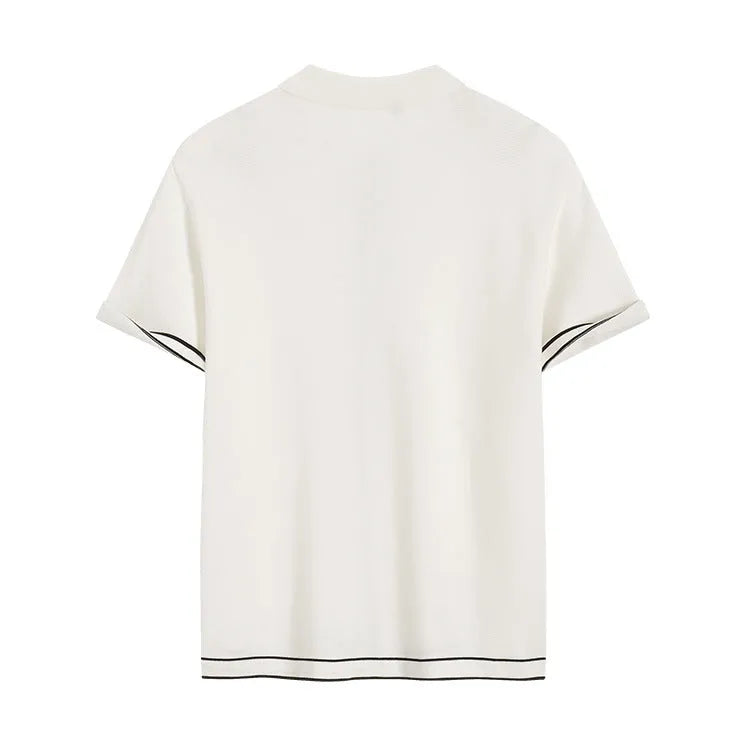 White short sleeve cardigan with dark contrast colour lapels, laid flat to show relaxed fit and button front.