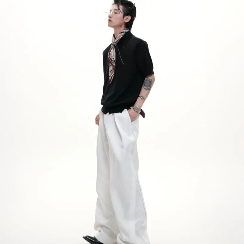 Man modelling a slim-fit black knitted polo shirt with an oblique zip closure and short sleeves.