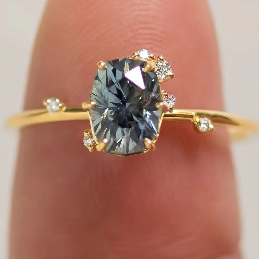 Gold plated women's ring with green zircon stone in floral design on model finger