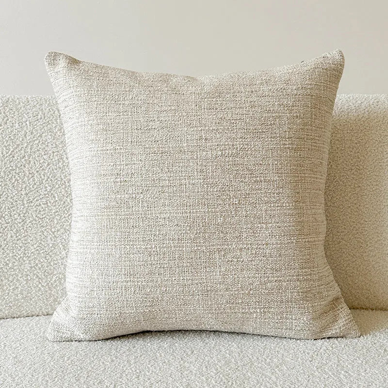 Amber American-style jacquard pillow cover with paisley and flower pattern on a sofa.