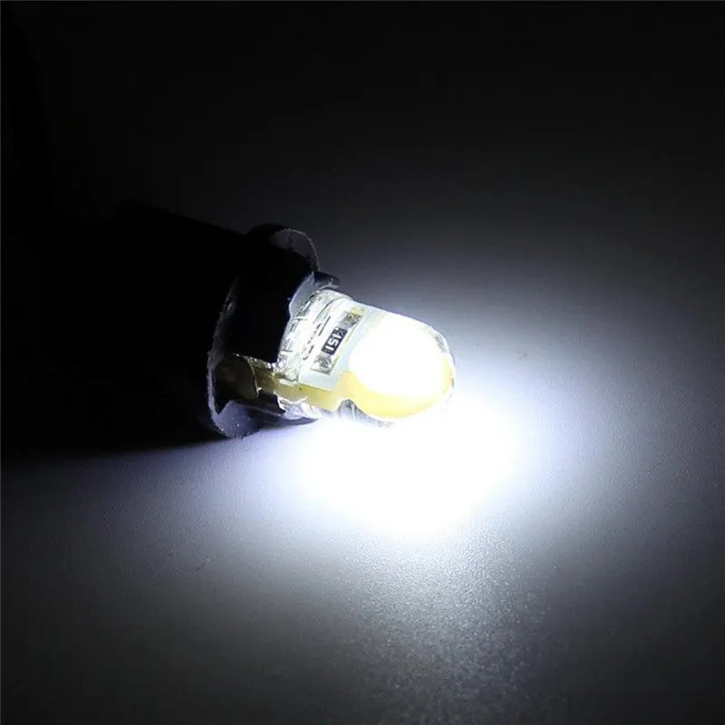 Ten T10 wedge base LED bulbs with silicone housing in a pack, showing multiple colour options