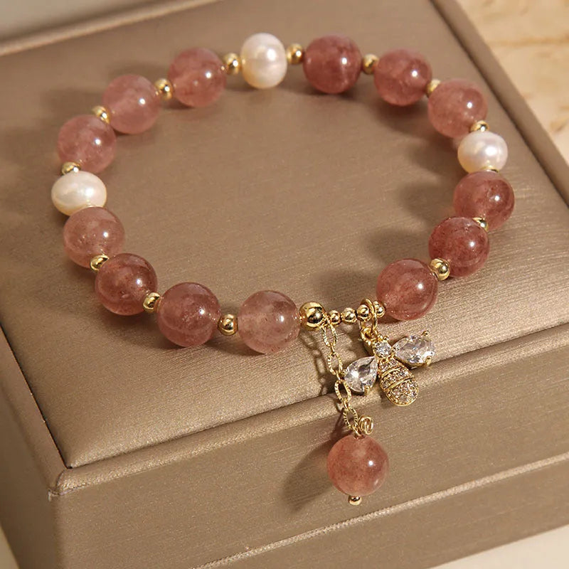 Women's bracelet with pink strawberry quartz stones, white freshwater pearls, and sparkling zircon on an alloy chain.