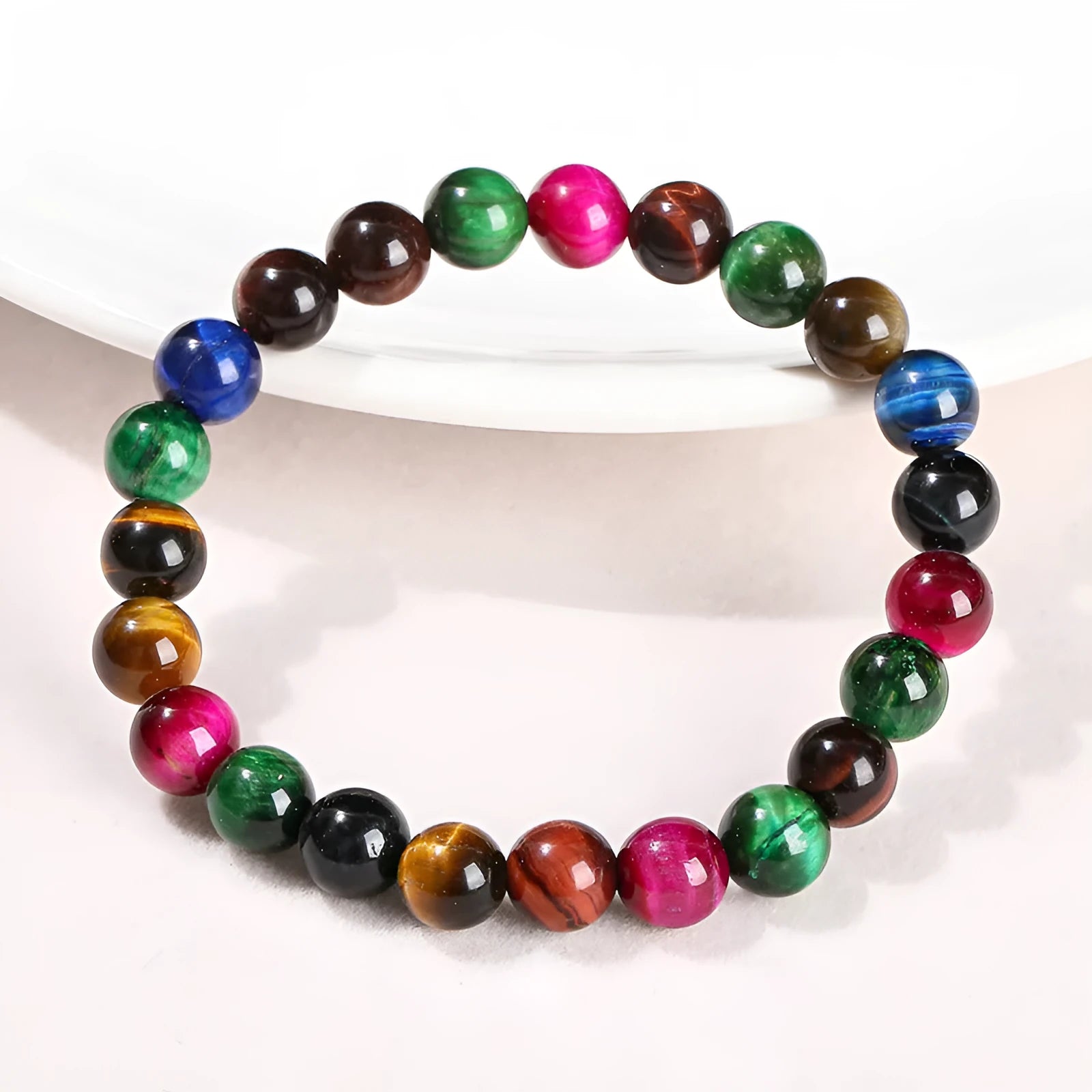 Colourful tiger's eye natural stone bracelet with round beads on a string lace, shown in unisex design.