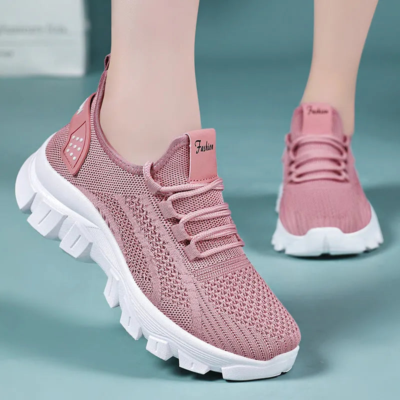 Women's white Flyknit sneakers with thick PVC sole and lace-up front on a neutral background.