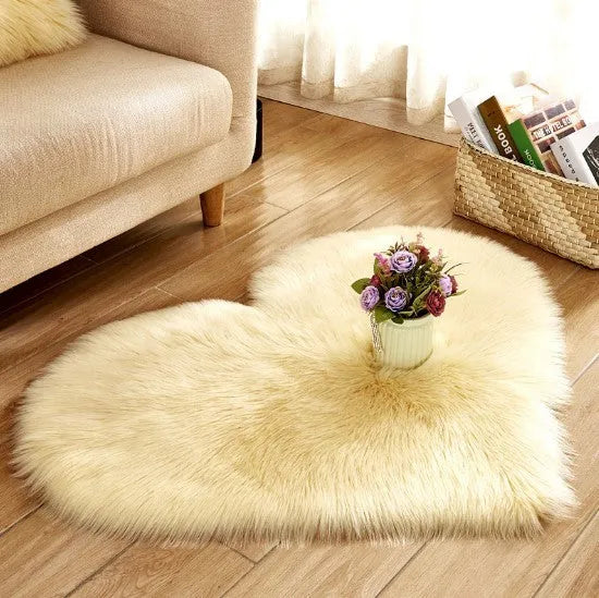 Heart-shaped plush carpet in multiple colours showing wool-like texture with 5-6 cm pile length