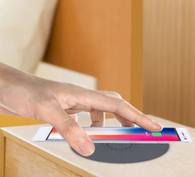 Black 60mm round wireless phone charging pad for furniture installation