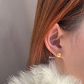 Large pearl stud earrings with a geometric star detail, shown in silver.