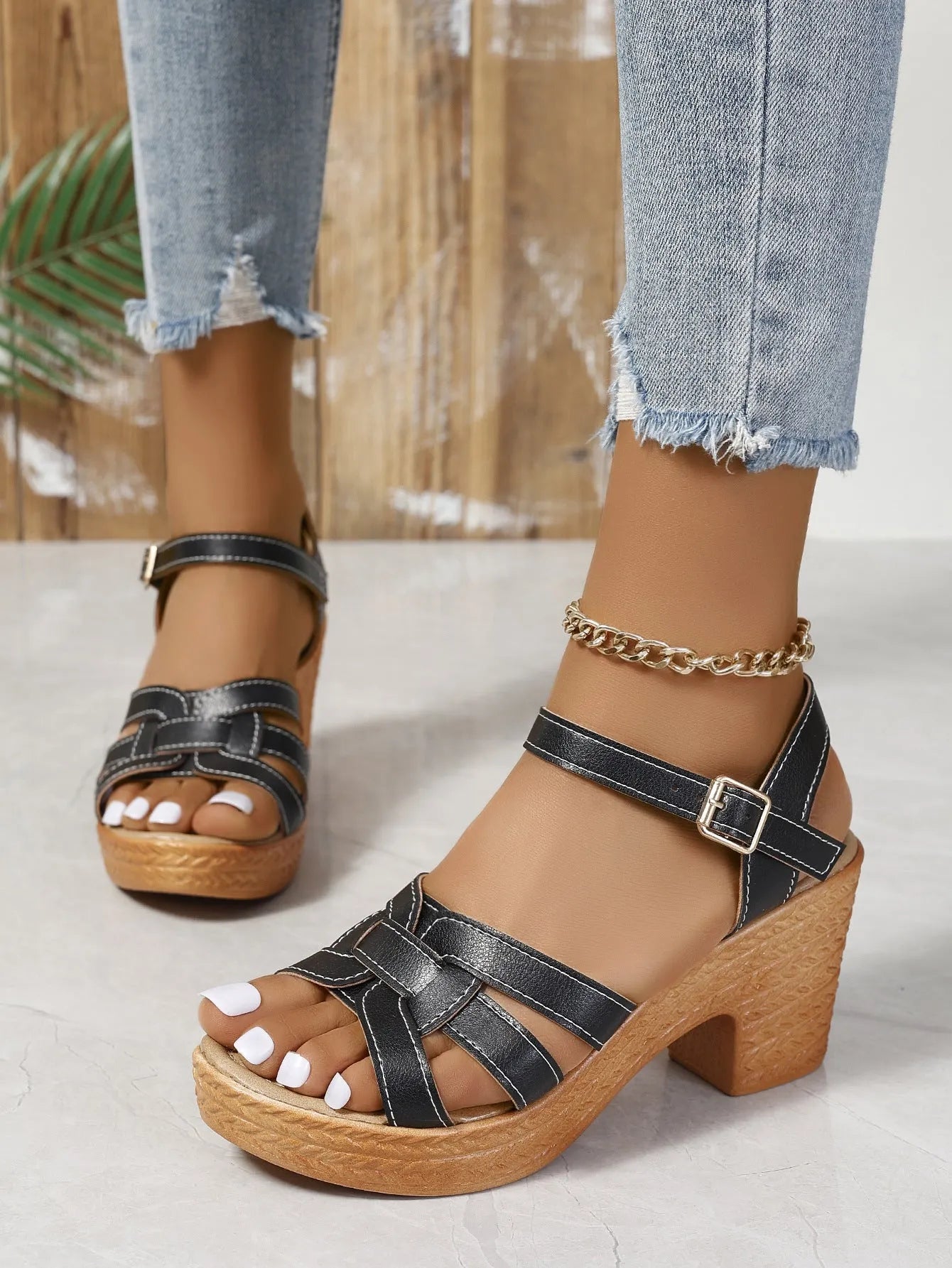 Plus size women's black peep toe sandals with chunky heel and ankle-strap buckle.