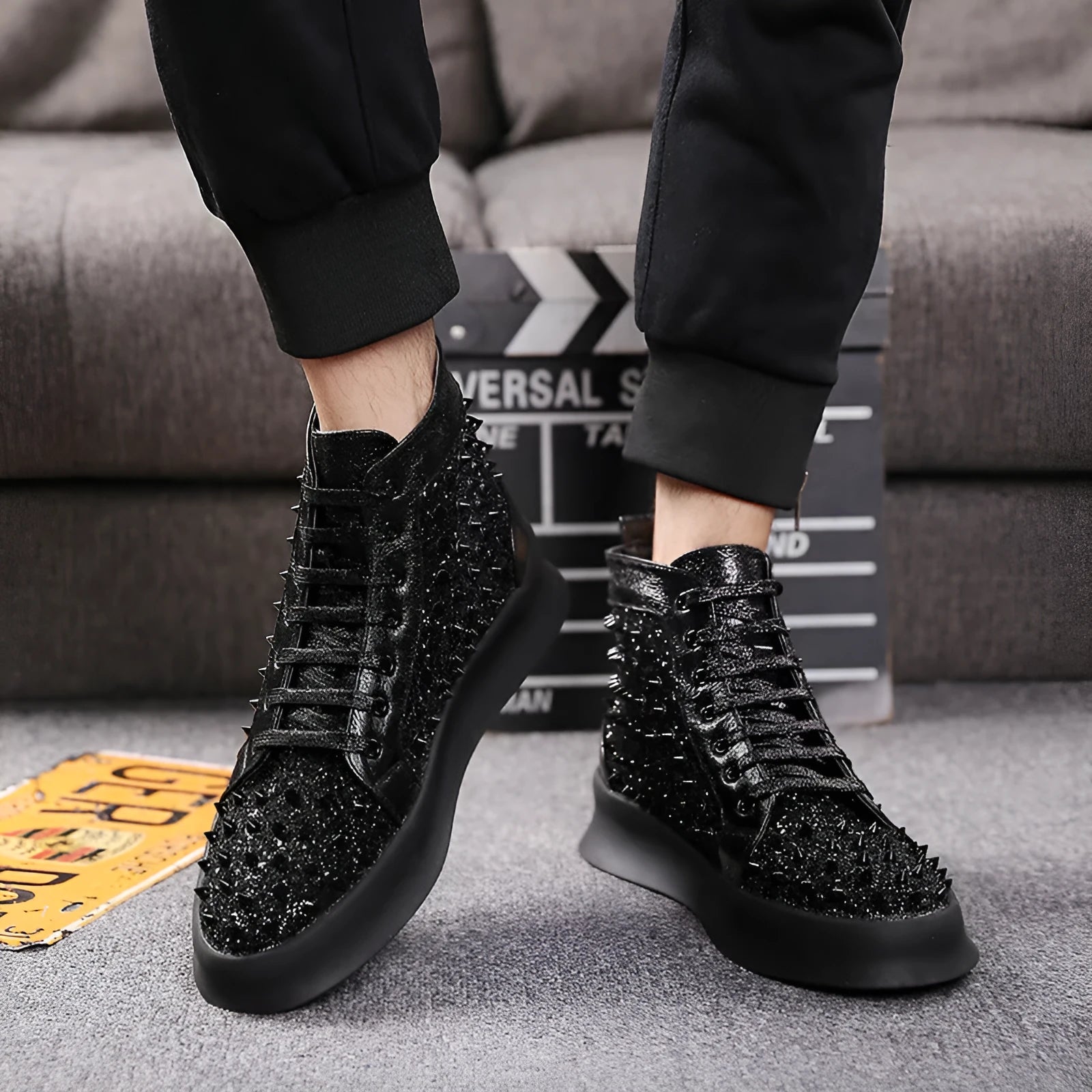 Men's black cowhide leather Martin boots with round toe and rivet detail on a flat surface