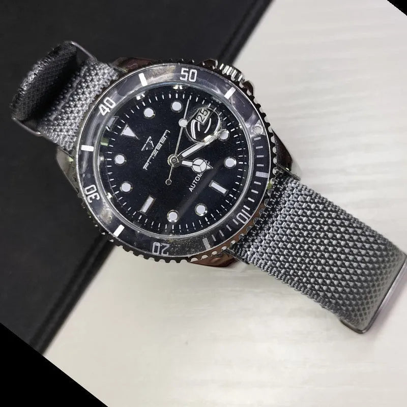 Nylon integrated watch strap in army green colour showing textile texture and buckle.