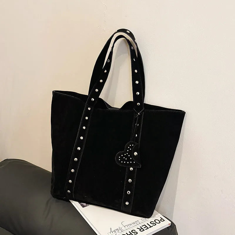 Black PU leather horizontal tote bag with double shoulder straps, showing outer sandwich pocket.