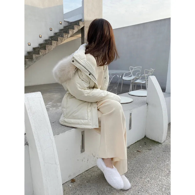 Women's high-waisted knitted wide-leg trousers in black, shown in a casual setting.