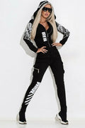 Black women's casual suit with wings print, featuring a hooded zip-up top and straight-leg trousers.