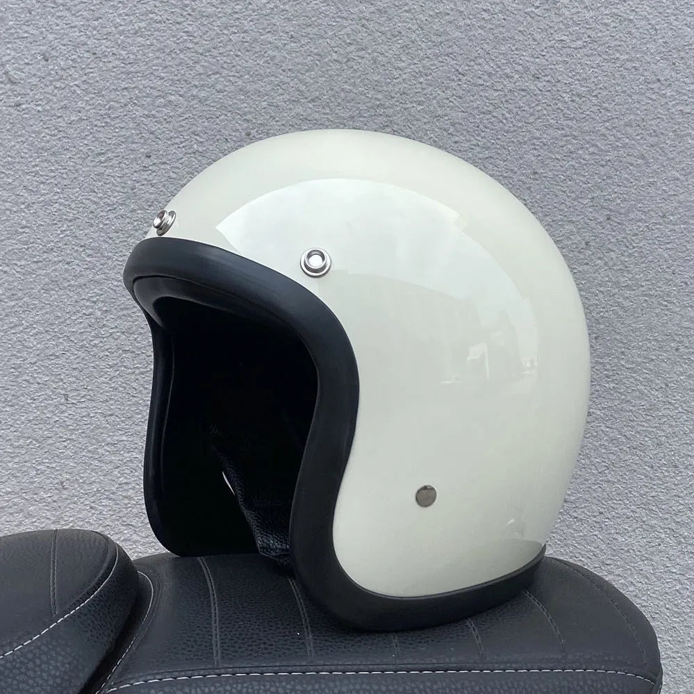Retro-style open-face motorcycle helmet in fibreglass, shown in a choice of colours including Cement Grey and Matte Black Flower.