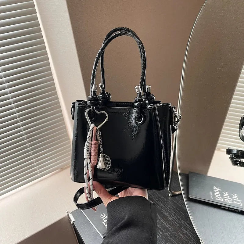 Women's medium-soft PU messenger bag in bucket shape with pendant, black, white, wine red, and pink options