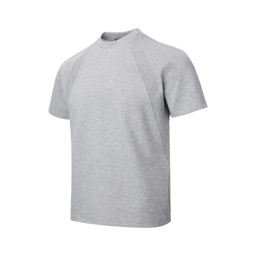 Men's loose fit short sleeve top in black with air layer stitching detail on a grey background.
