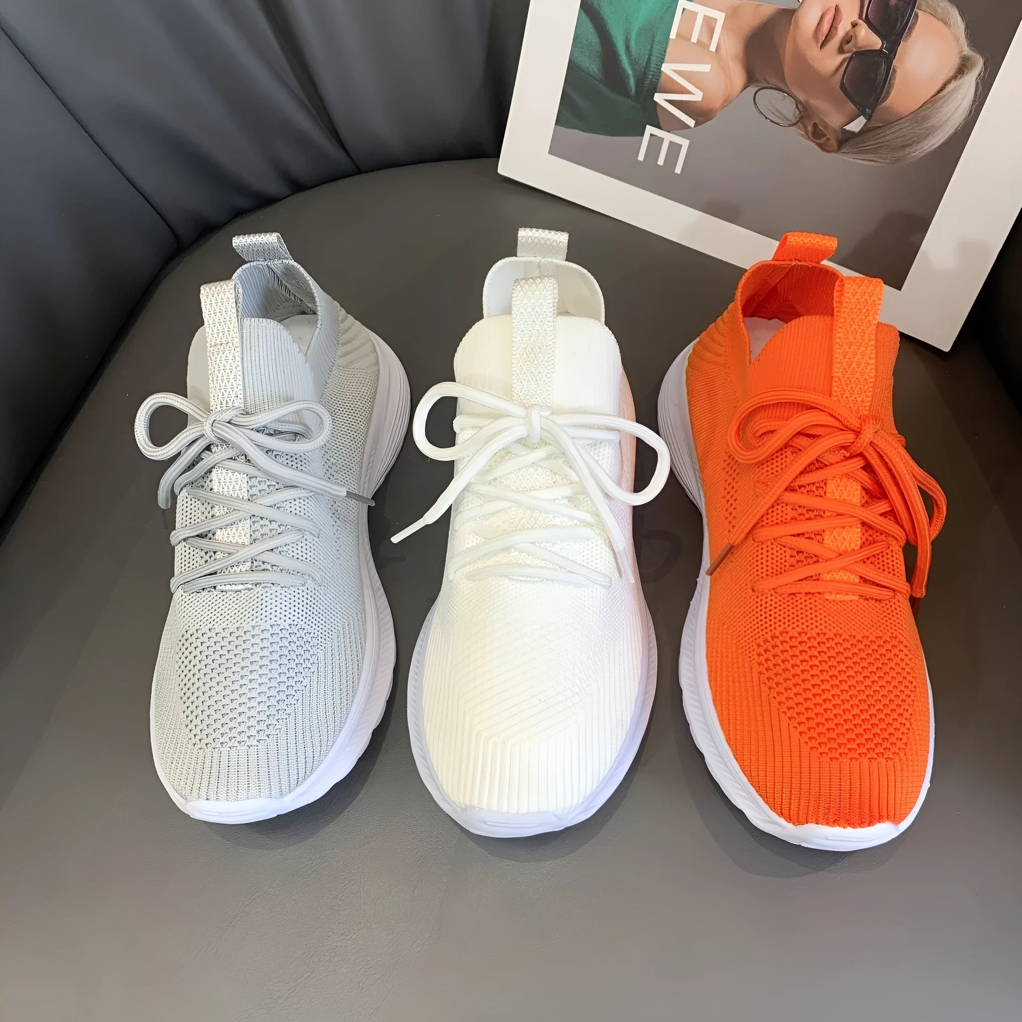Women's low-top mesh running shoes in creamy white with a Flyknit upper and flat rubber sole.
