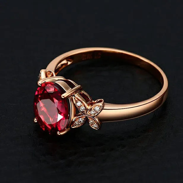 Women's butterfly-shaped ring with heart crystal in rose gold plating on blue or red background