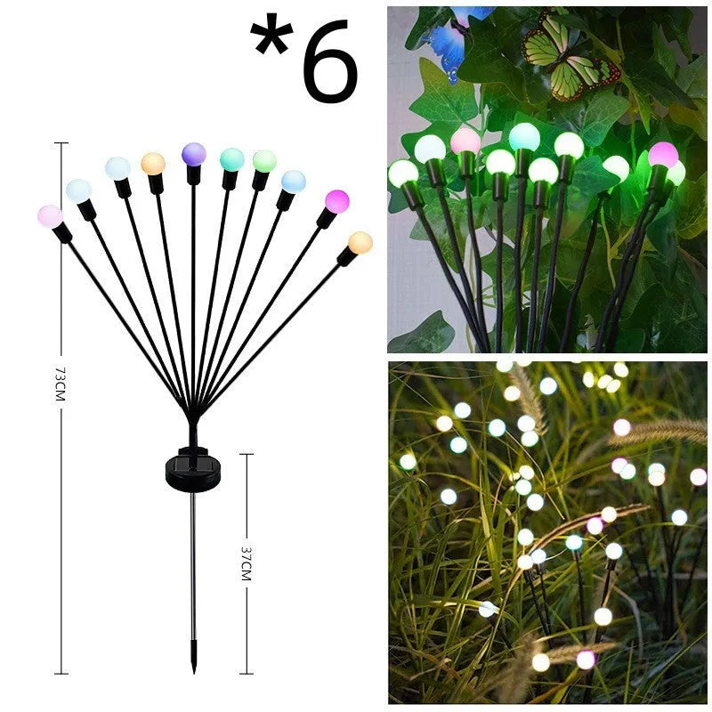 Solar-powered LED firefly garden spike light with multiple heads and a press-in ground plug on grass.