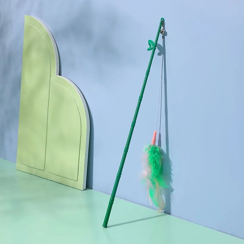 Green interactive cat feather wand toy with bell attachment on a durable stick
