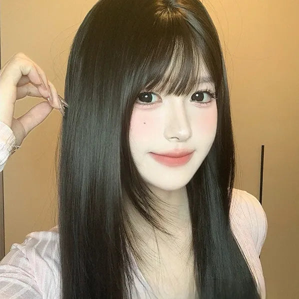A dark brown long straight synthetic wig with a fringe on a wig stand.