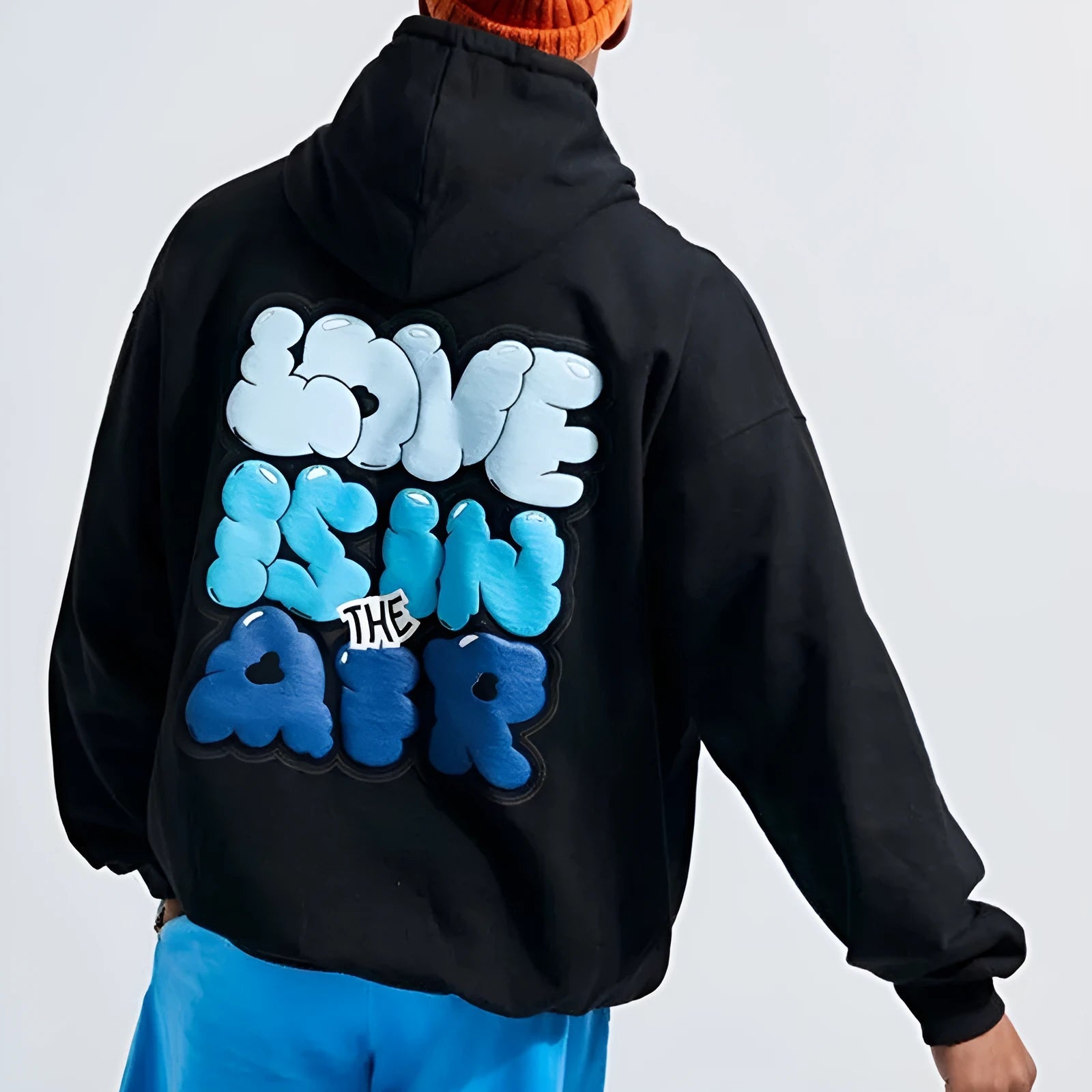 Black cotton blend pullover hoodie with milk bottle and lemon print on front, plus velvet finish