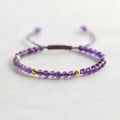 Handmade purple amethyst and 14K gold bracelet with 4mm round beads on a wrist.