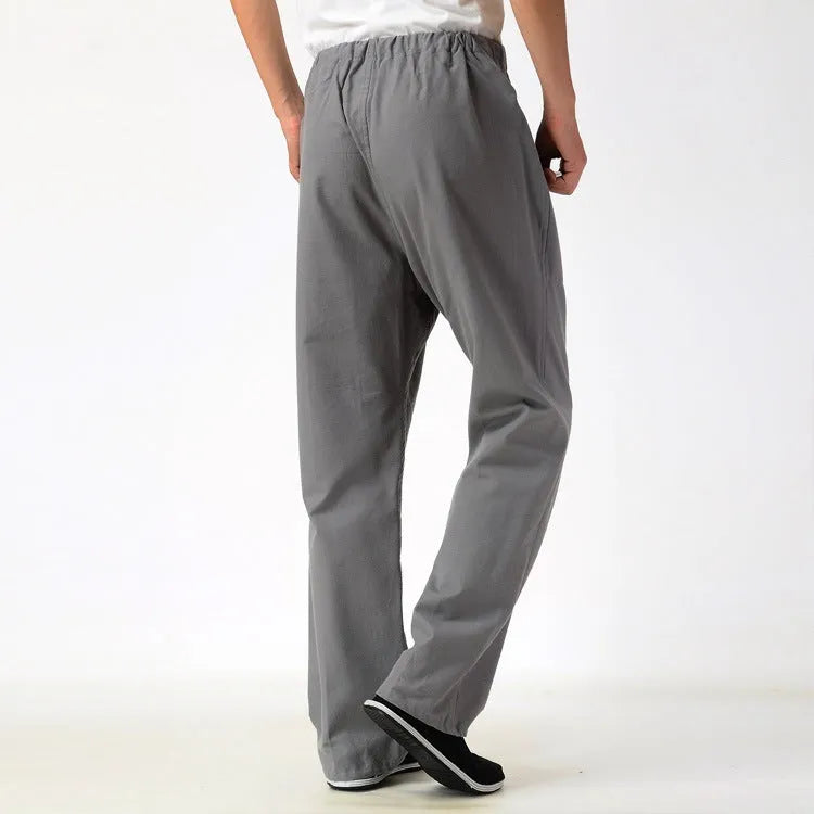 Men's beige pure cotton casual trousers with drawstring waist and belt on a neutral background.