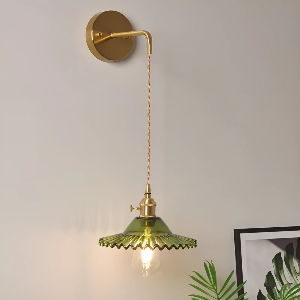 Retro brass lotus wall lamp with glass shade mounted on a beige wall, showcasing its copper arm and layered design.