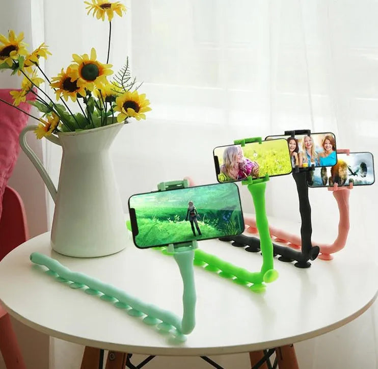 Black flexible rubber phone holder with suction cup extended to 62cm length on a desktop