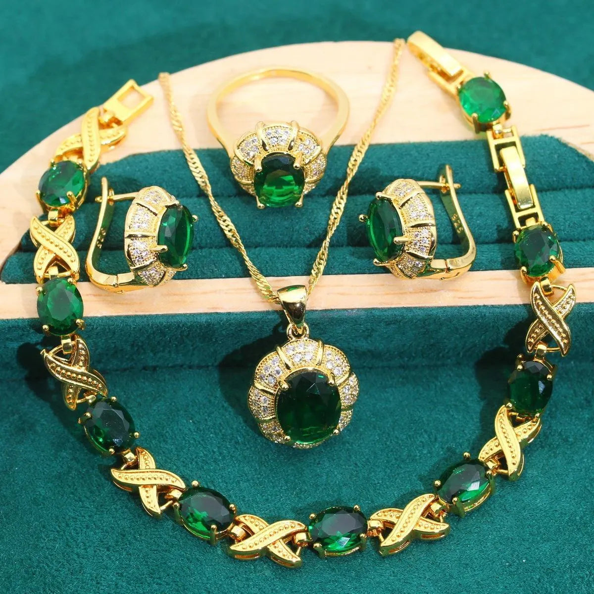 18k gold plated zircon jewellery set with necklace, earrings, ring, and bracelet on blue background
