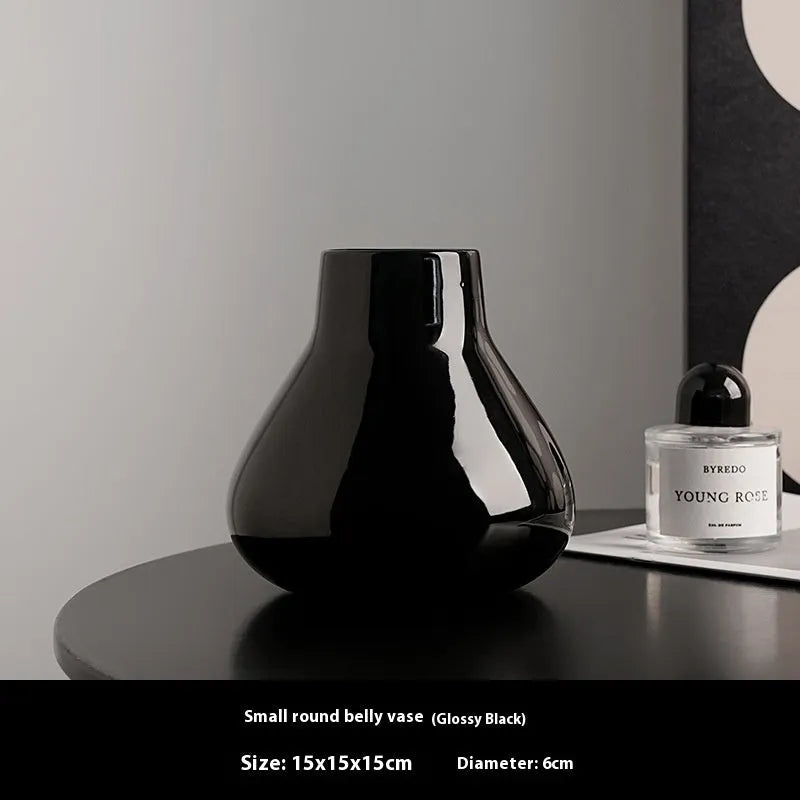 Modern ceramic vase with two white artificial orchid stems in minimalist home setting