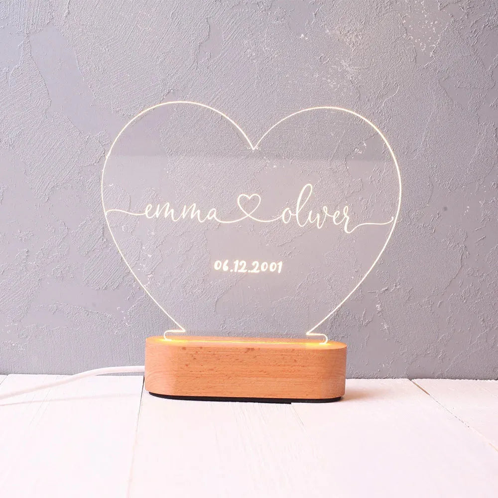 Custom acrylic LED night light with engraved names and date for Valentine's Day.